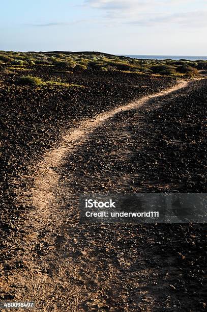 Stony Road At Volcanic Desert Stock Photo - Download Image Now - Desert Area, Direction, Dirt
