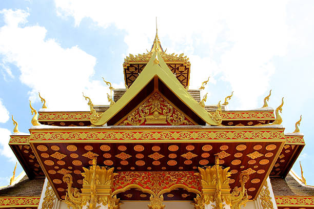 Lodges at the corner of some Vientiane quiest streets, this recent white and gold Wat glow under a brilliant sun.