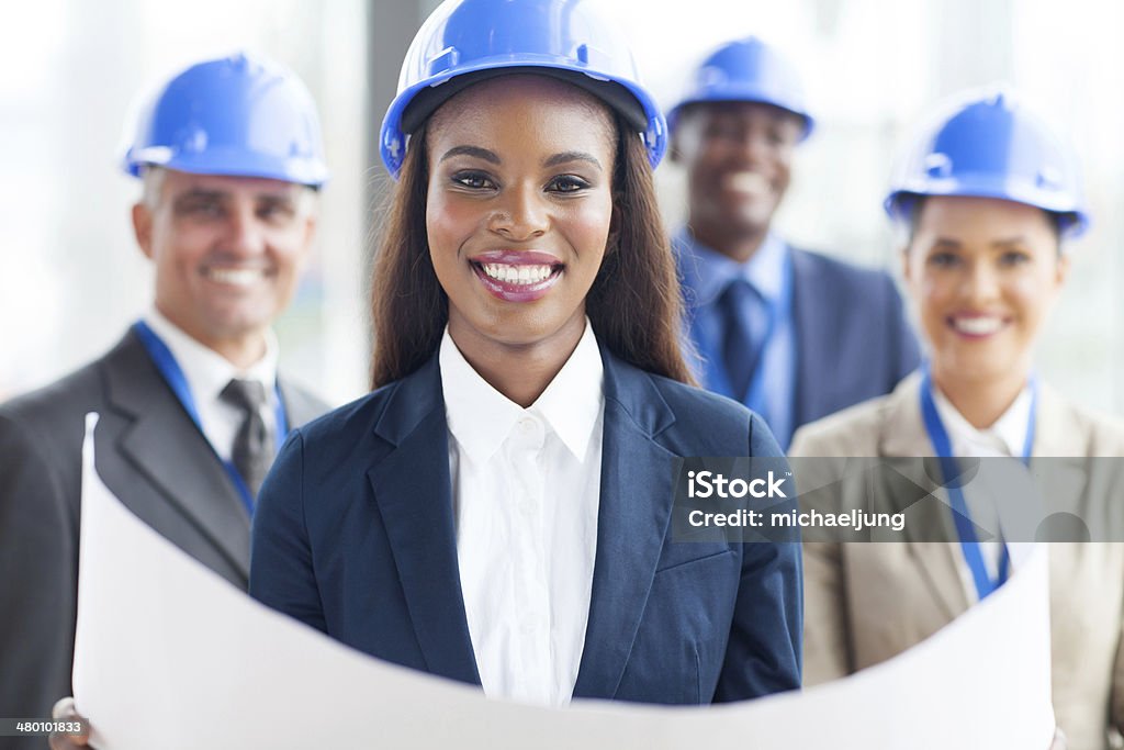 african american female architect happy african american female architect with team on background Construction Industry Stock Photo