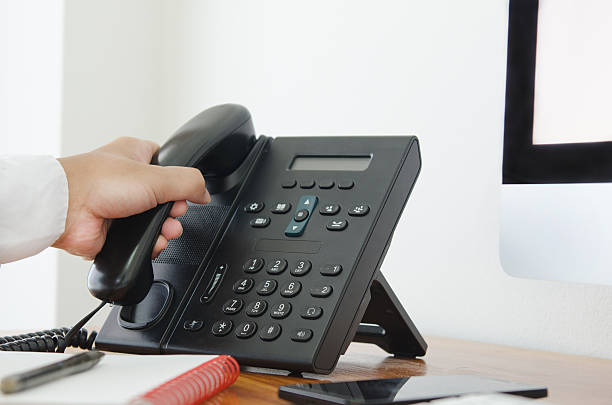 istock hand hold a telephone in the office 480102768