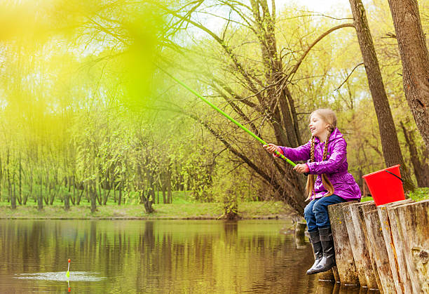 prazer de pesca pequena menina bonita perto de lago - ticket ticket stub park fun imagens e fotografias de stock