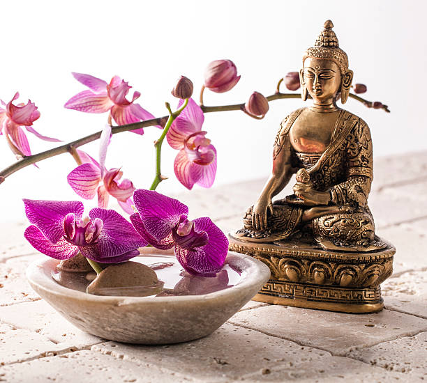 istock Buddha for zen attitude with stone and flowers 480107422