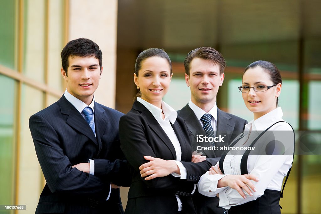 Business team Portrait of confident business partners in smart suits looking at camera with smiles   Note to inspector: the image is pre-Sept 1 2009 2015 Stock Photo