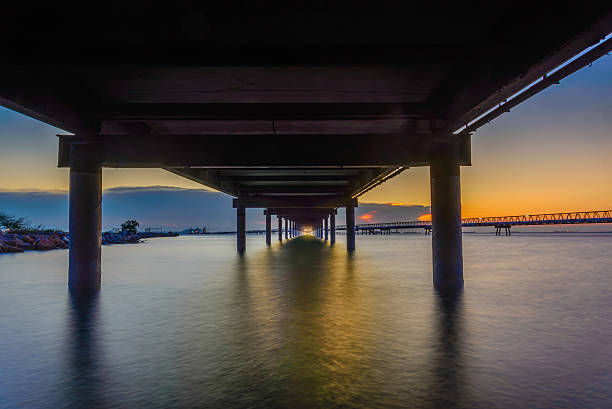 istock sunset in the sea and transport bridge 480108026