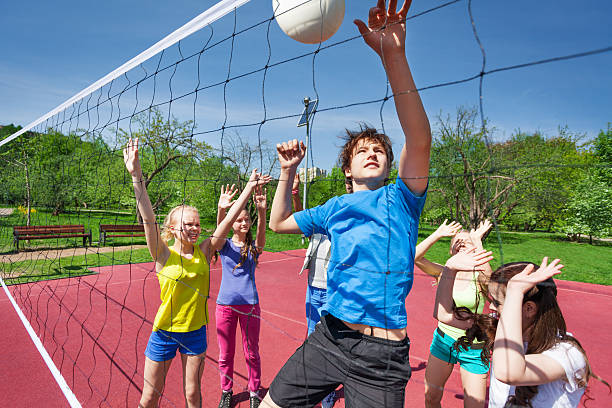 istock Jumping boy for ball plays volleyball with teens 480108108