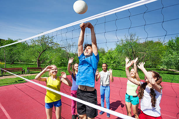 istock Teens all are with arms up play volleyball 480108112