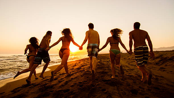 istock Group of friends running at the beach 480110960