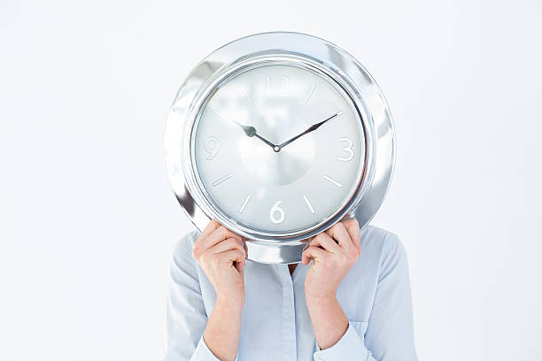 istock Businesswoman in suit holding a clock 480111044