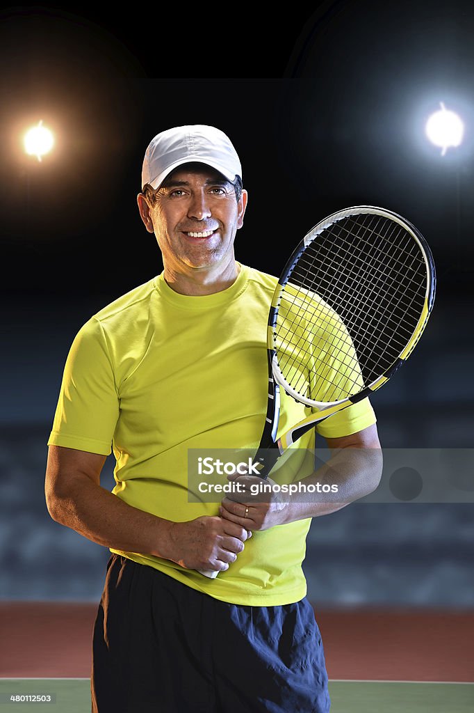 Hispanic Senior Tennis Player Portrait of Hispanic senior player holding raquet standing on tennis court 50-59 Years Stock Photo