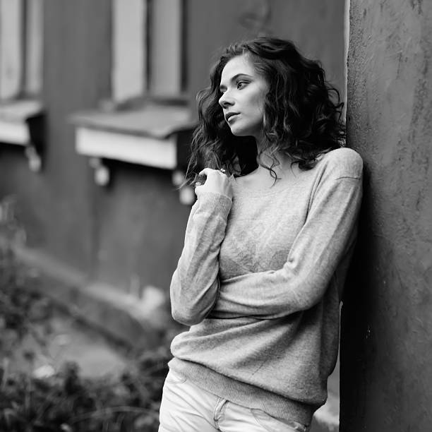 istock Young woman against old house 480112581