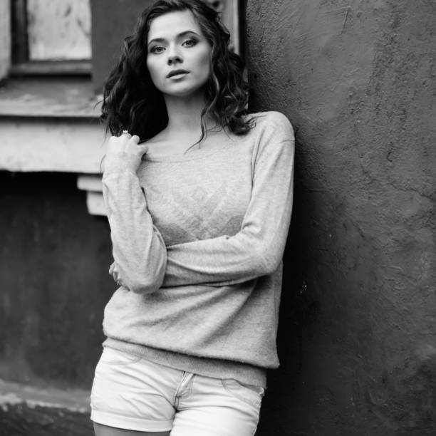 istock Young woman against old house 480112597