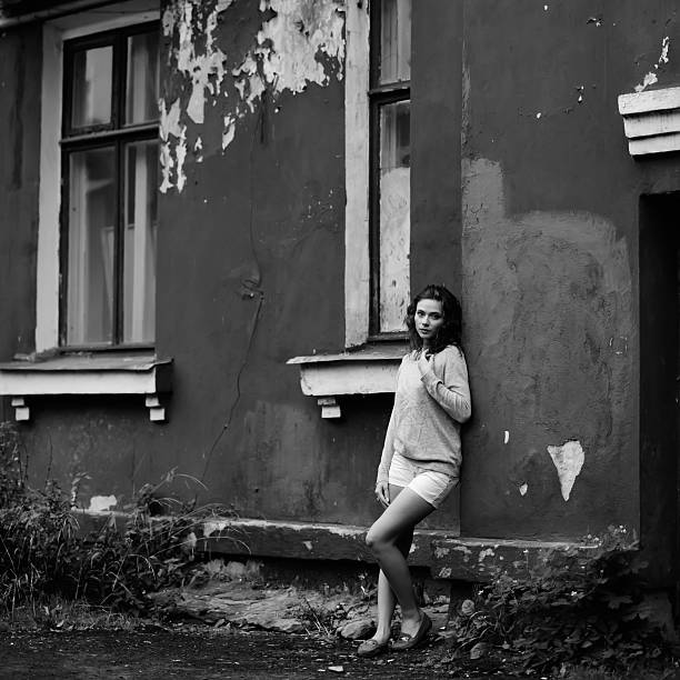 istock Young woman against old house 480112787