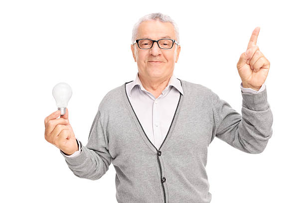 istock Senior holding a light bulb and pointing with his finger 480112940