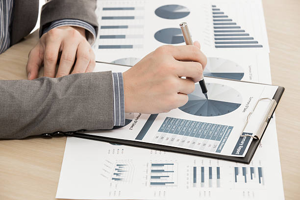 istock business report and man hand with pen 480113047