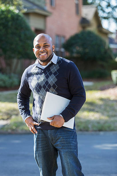 istock Black man standing outdoors on residential street 480114380