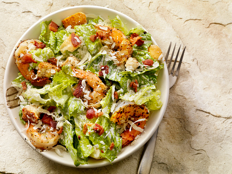 Caesar Salad with Romain Lettuce, Bacon, Capers, Croutons, Freshly Grated Parmesan Cheese and a Toasted Baguette  -Photographed on Hasselblad H3D2-39mb Camera