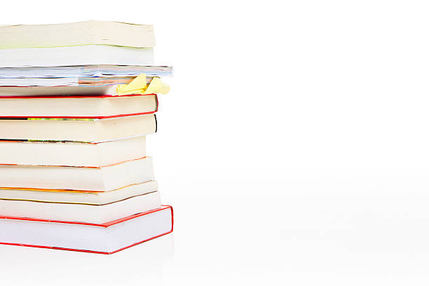 Stack of books Stack of books isolated on white background handbook book hardcover book red stock pictures, royalty-free photos & images