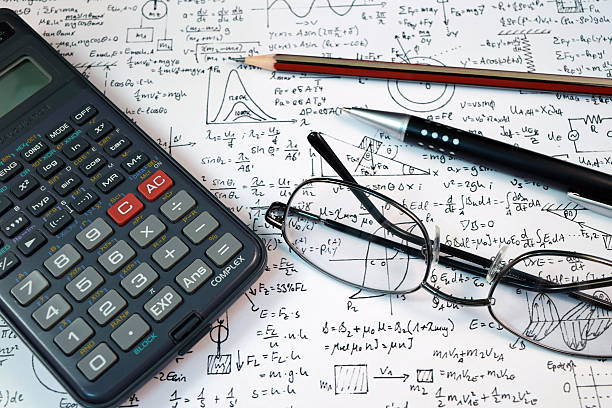 istock Eye Glasses, pen and pencil over the Formula with calculator 480114586