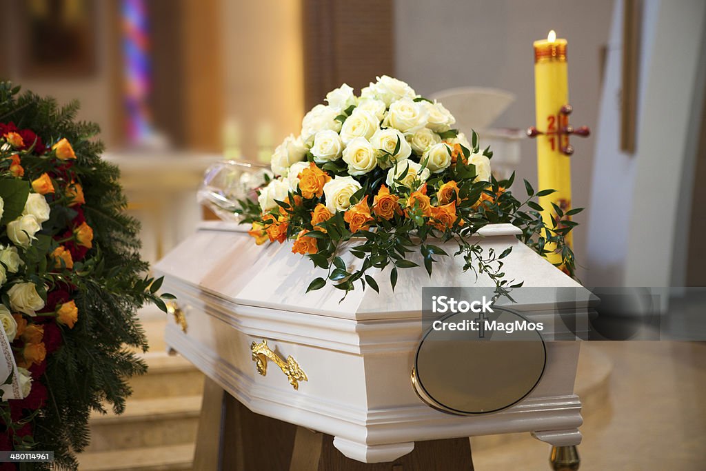 White Coffin, wreath, candle in the Catholic Church Funeral Stock Photo