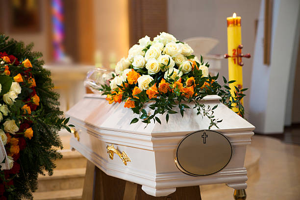 White Coffin, wreath, candle in the Catholic Church White Coffin, wreath, candle in the Catholic Church funeral parlor photos stock pictures, royalty-free photos & images
