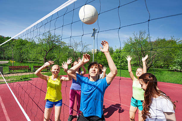 istock Teens in motion with arms up try to catch ball 480115228