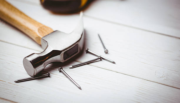 istock Hammer and nails laid out on table 480118398