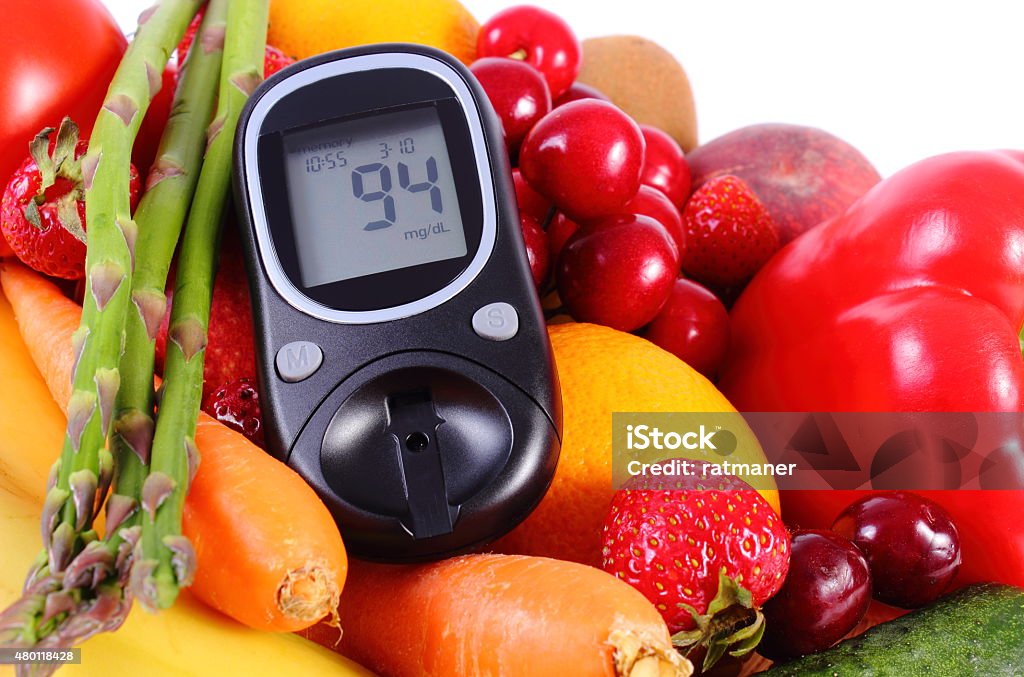 Glucometer with fruits and vegetables, healthy nutrition, diabetes Glucose meter with fresh ripe fruits and vegetables, concept of diabetes, healthy food, nutrition and strengthening immunity 2015 Stock Photo