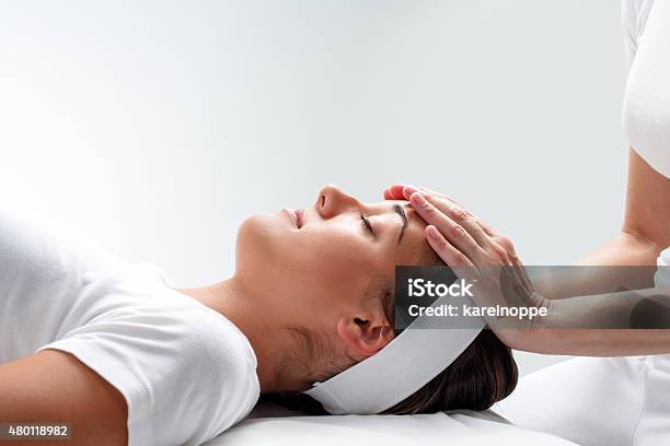 Woman Relaxing At Reiki Session Stock Photo - Download Image Now - Reiki, Alternative Therapy, Physical Therapy
