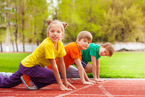 istock Children stand with bended knee ready to run 480119048