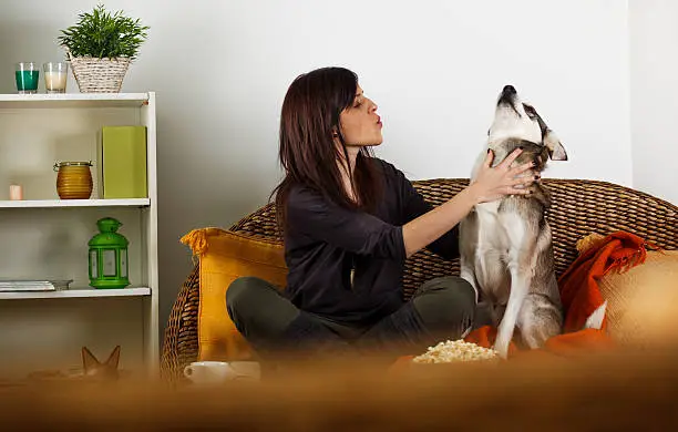 Photo of Young woman singing with her dog