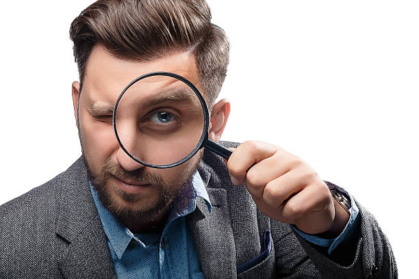 istock Man with magnifying glass on white background 480121426