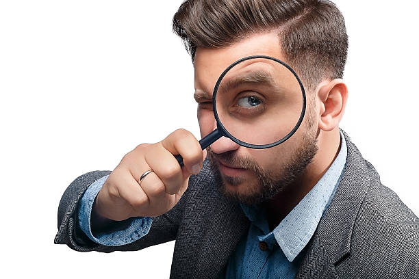 istock Man with magnifying glass on white background 480121442