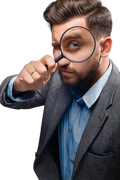 istock Man with magnifying glass on white background 480121444