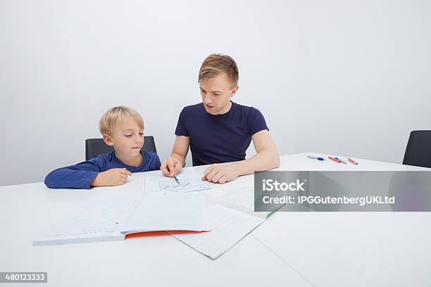 Mid Adult Father Assisting Boy In Studies Stock Photo - Download Image Now - 30-34 Years, 30-39 Years, 4-5 Years