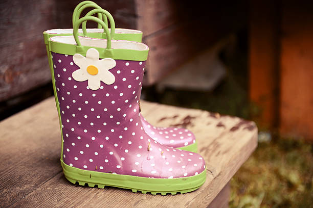 istock rubber boots with dots on a wooden background 480125340