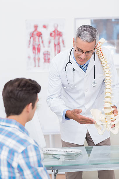 istock Doctor explaining a spine model to patient 480125900
