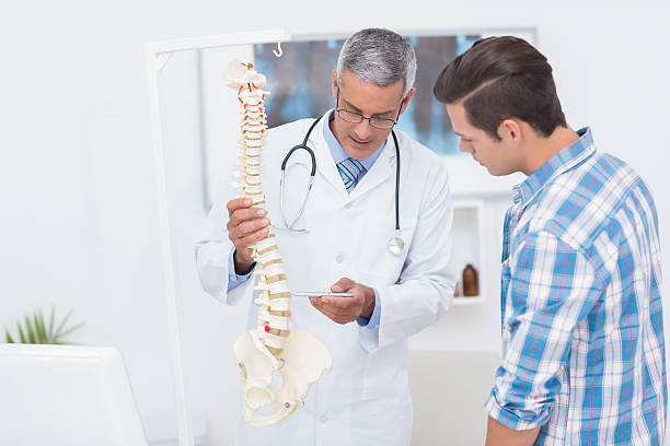 istock Doctor explaining the spine to his patient 480125910