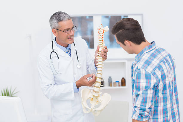 istock Doctor explaining the spine to his patient 480125914