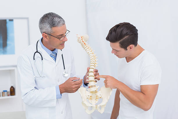 istock Doctor explaining anatomical spine to his patient 480126064