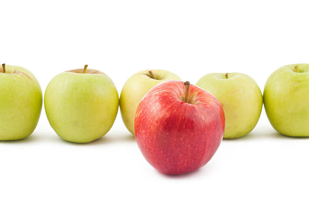 istock Red apple ahead of the green on white 480126790