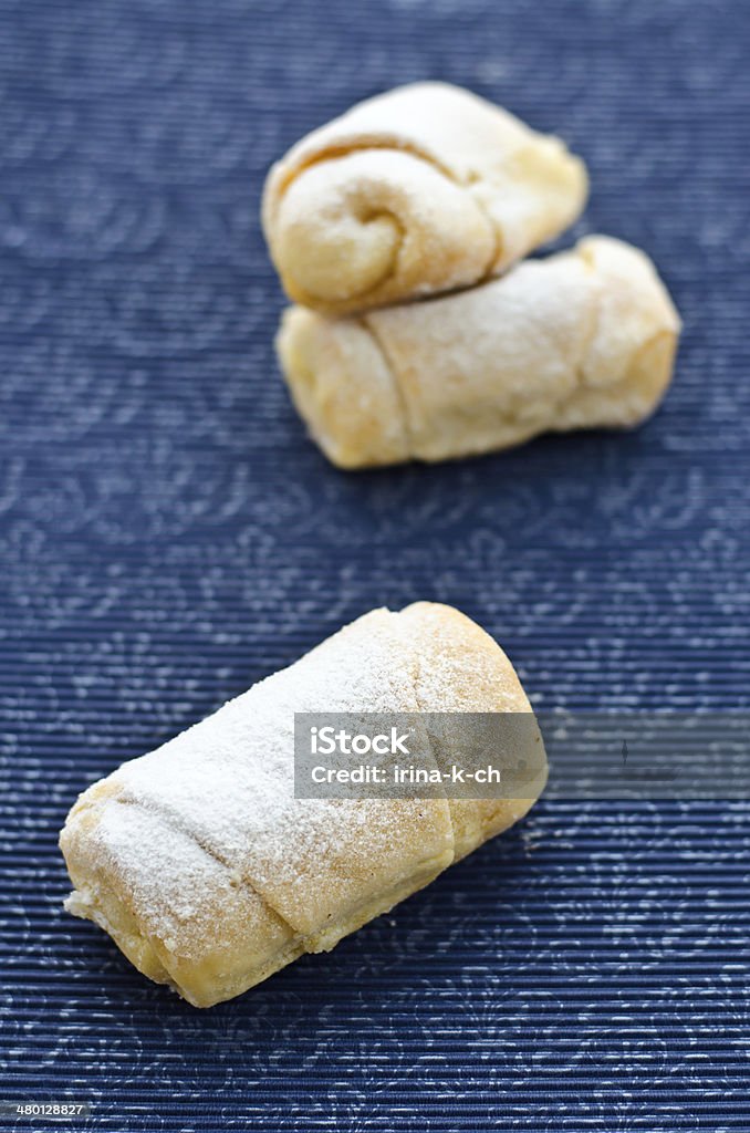 rolls with cottage cheese Rolls with cream cheese and powdered sugar on a stand with a pattern. Baked Stock Photo