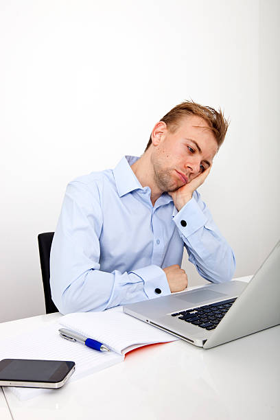istock Tired businessman with laptop on desk in office 480129037