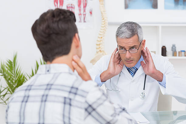 istock Doctor examining patient with neck ache 480129586