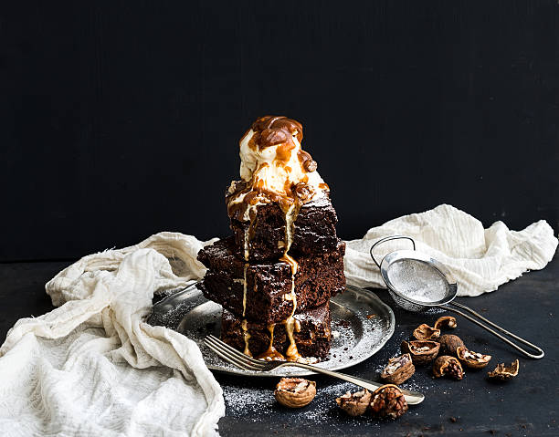 istock Fudgy Brownies tower with salted caramel, walnuts and ice-cream 480129996