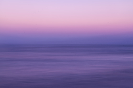 Beautiful romantic sundown on the island Koh Tunsay in Cambodia. Purple and blue colored, with long-exposure to give it a surreal feeling.
