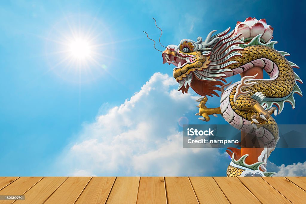 Dragon,Sun Flare Dragon, sun flare with wood floor on blue sky background 2015 Stock Photo