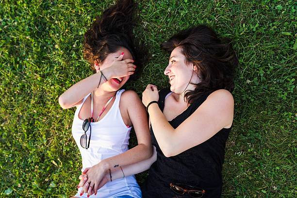 istock Young women joke lying on the park 480132150