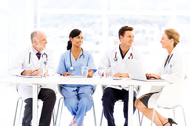 istock Multi Ethnic Medical Team Sitting At Conference Table 480132450