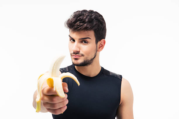 istock Handsome young man holding banana 480132962