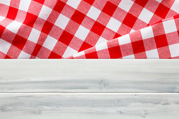 istock Red Checked Napkin on Rough Wood and Grass 480133308
